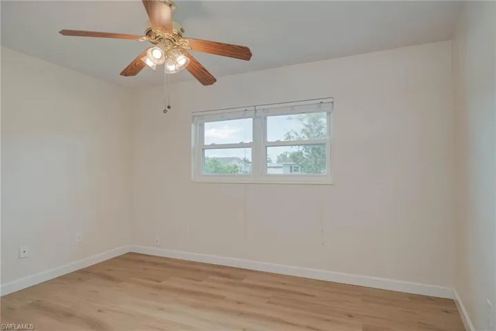 Spare room with light wood-style flooring and a ceiling fan