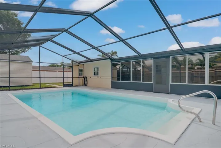 View of pool featuring a sunroom, a patio area, and a lanai