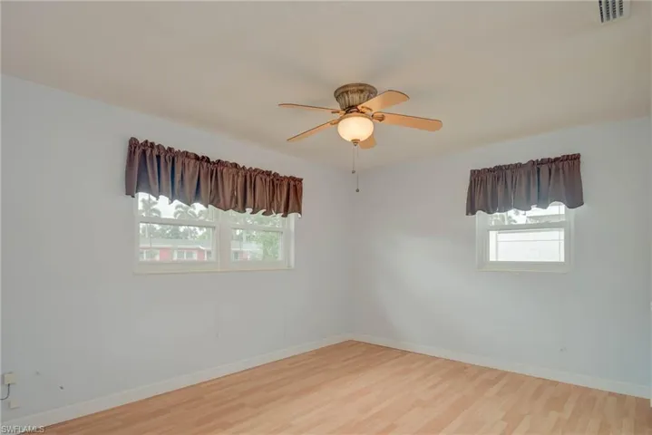 Spare room with light wood-type flooring and ceiling fan