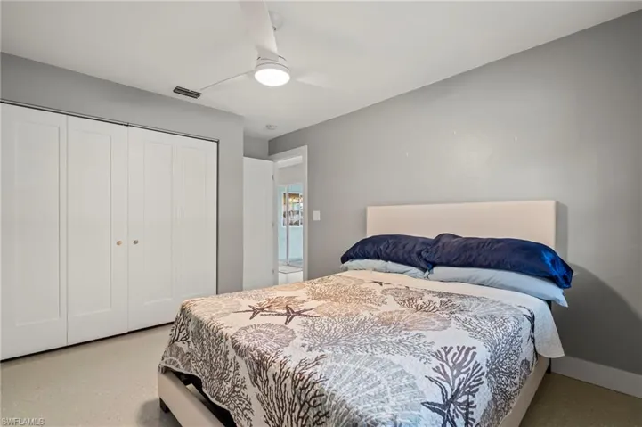 Bedroom with ceiling fan and a closet