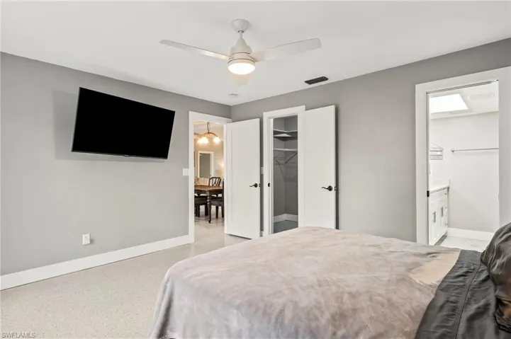 Bedroom with ceiling fan, connected bathroom, a spacious closet, and a closet