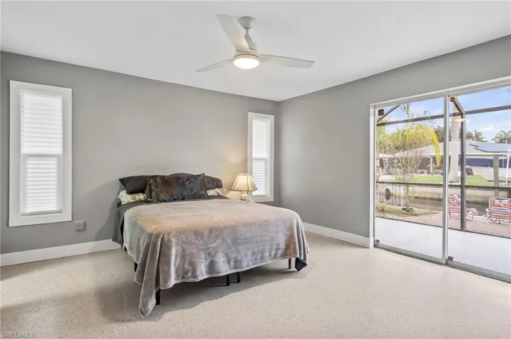 Bedroom with access to outside and ceiling fan