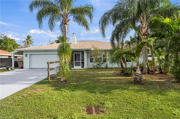 Ranch-style home with a garage and a front yard