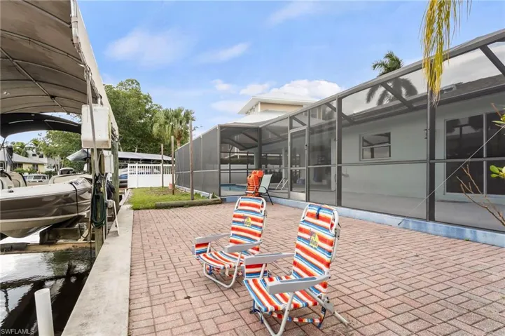 View of patio / terrace featuring a lanai and a dock