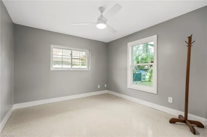 Empty room featuring plenty of natural light and ceiling fan