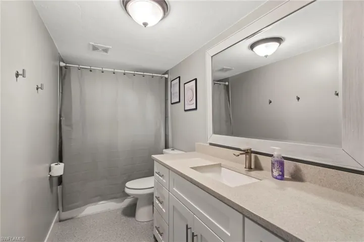 Bathroom featuring vanity and toilet