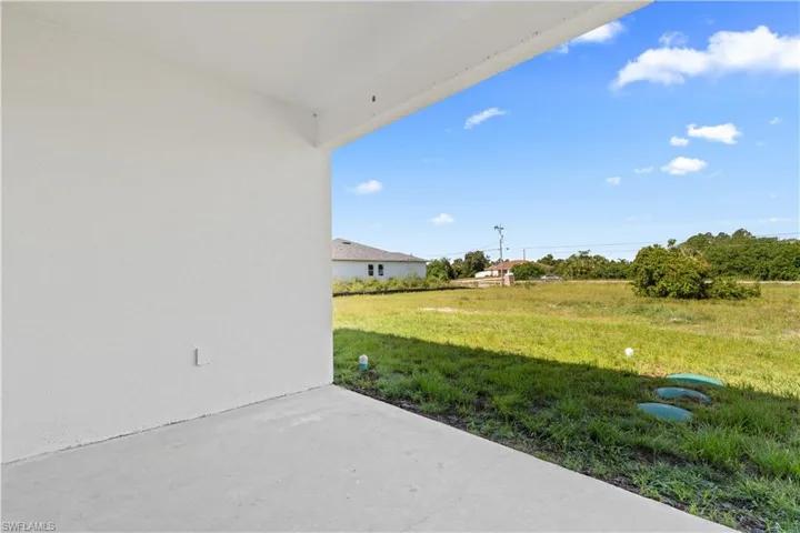 View of grassy yard with a patio