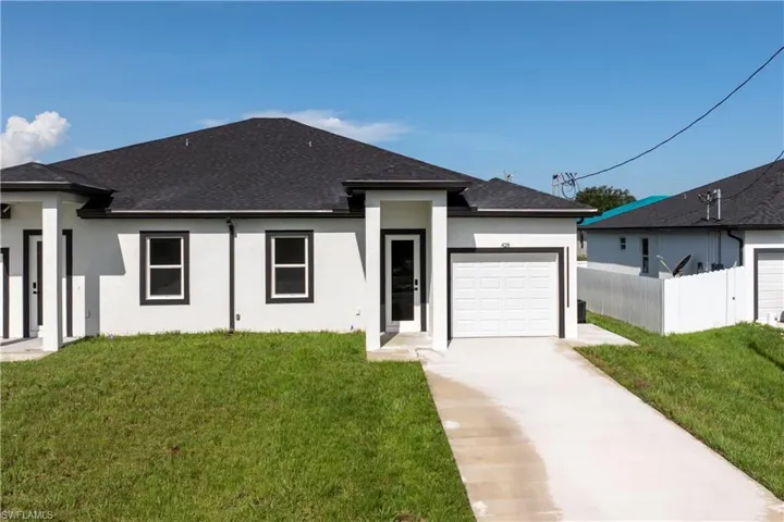 View of front of property featuring stucco siding, driveway, a garage, and a shingled roof