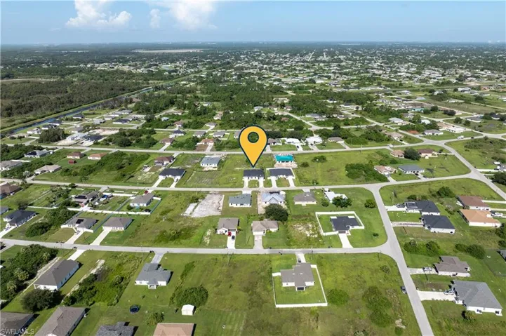 Aerial overview of property's location with nearby suburban area