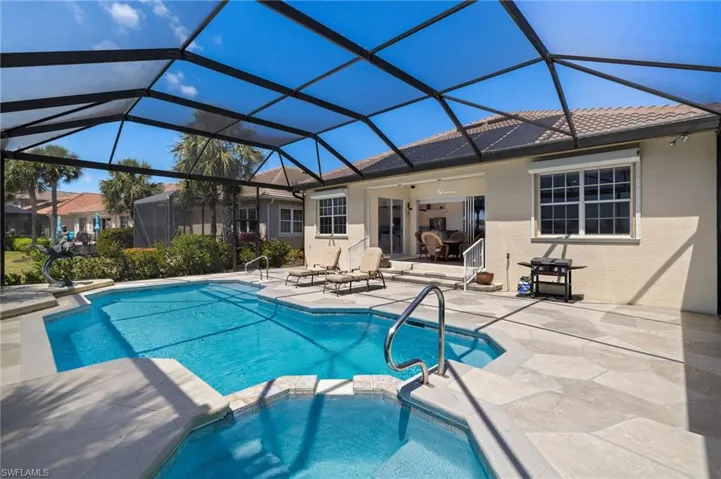 View of pool featuring a pool with connected hot tub and a patio