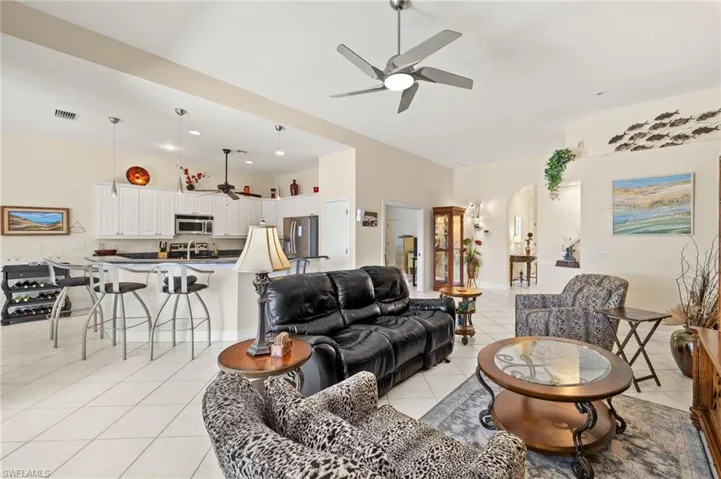 Living room with recessed lighting, visible vents, a ceiling fan, and light tile patterned floors