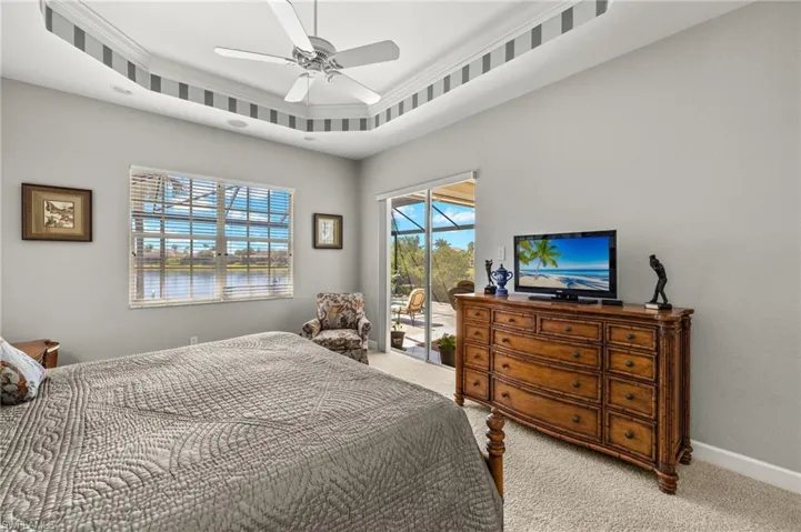 Carpeted bedroom featuring baseboards, access to outside, and ceiling fan