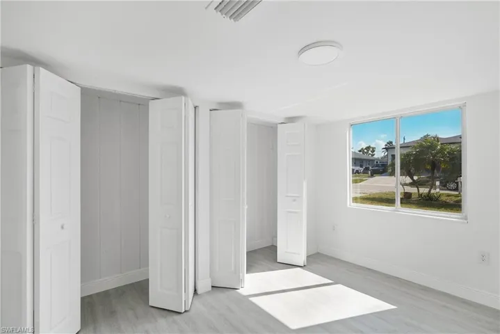 Apartment 1 Unfurnished bedroom featuring light hardwood / wood-style floors