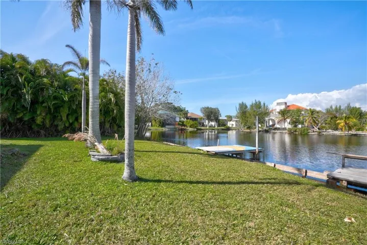 View of dock featuring a water view and a yard