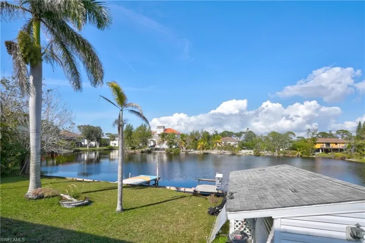 View of dock featuring a water view and a yard