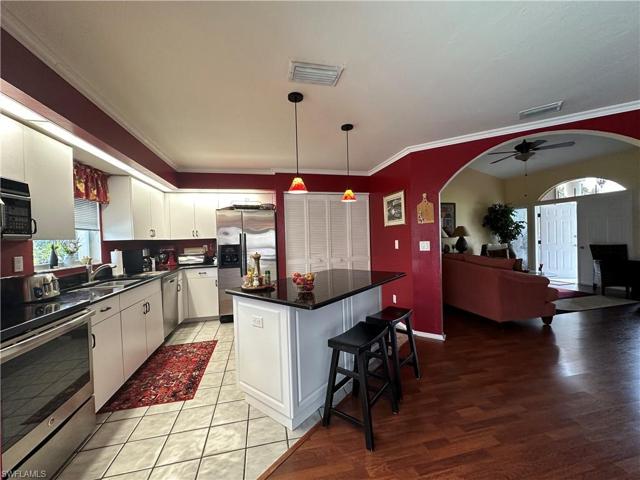 Stainless Steel Appliances, Stunning Black Granite & a View of the Pool Area