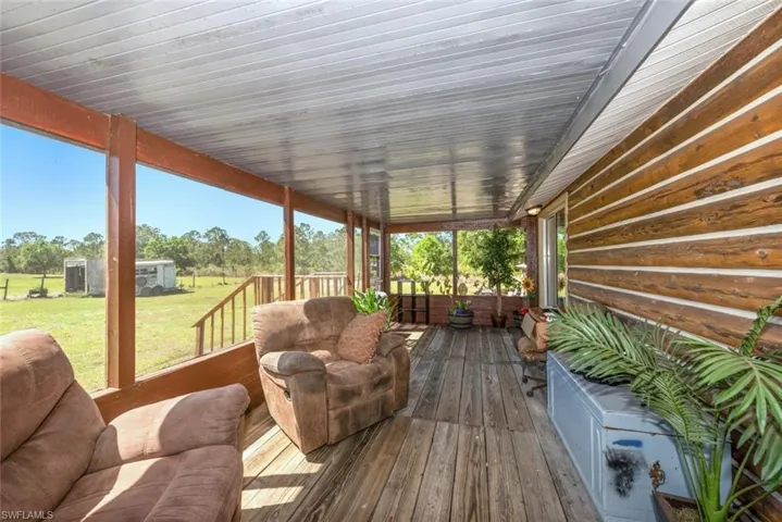Wooden deck with a lawn and an outdoor structure