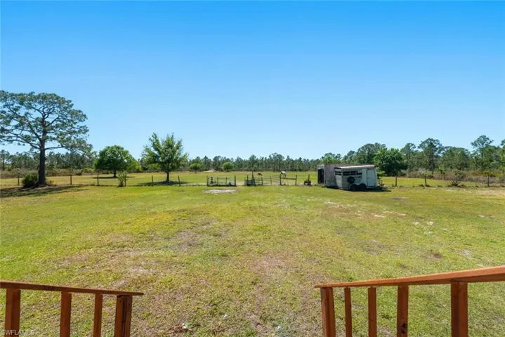 View of yard featuring a rural view and fence