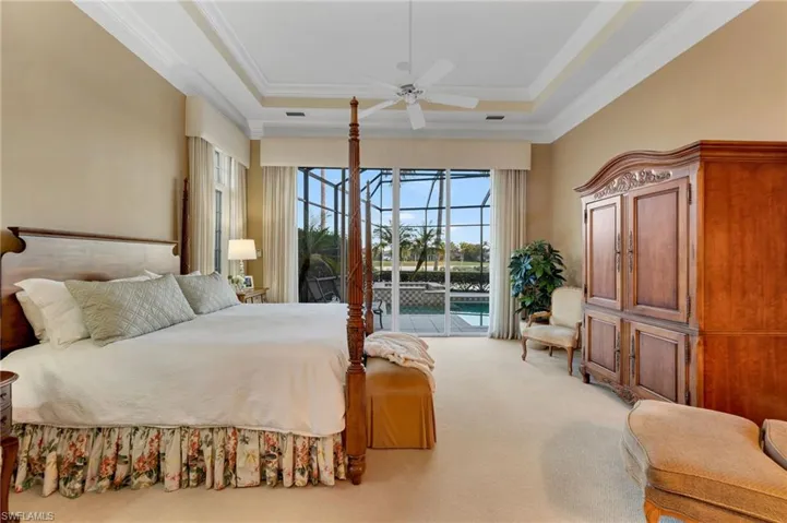 The Primary Suite has incredible views to the pool, lake and golf course beyond.