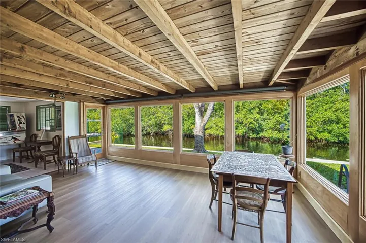 Sunroom / solarium featuring beam ceiling and wooden ceiling
