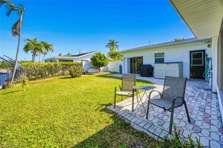 View of yard with a patio and fence