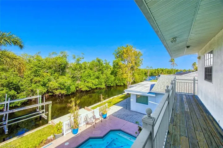 Balcony featuring a water view and a patio