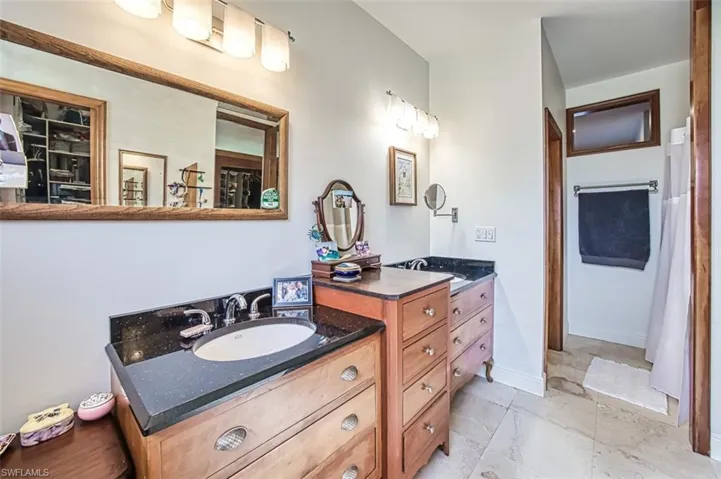 Bathroom with vanity and baseboards