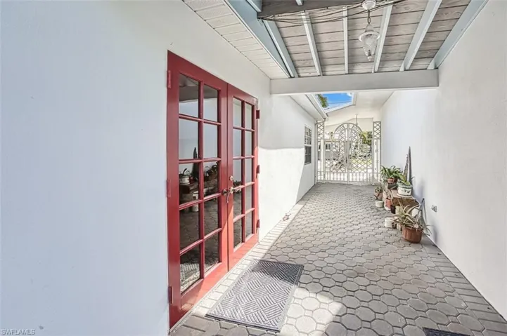 Hall featuring vaulted ceiling with skylight