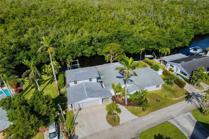 Birds eye view of property with a water view