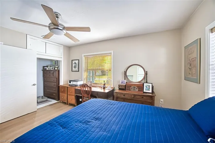 Bedroom with ceiling fan and light wood-style floors