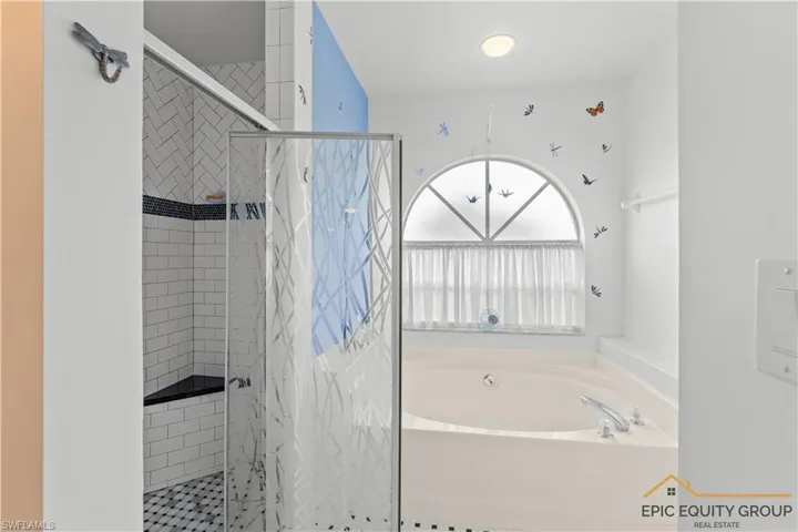 Full bath with a shower stall and a garden tub