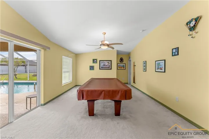 Rec room featuring pool table, lofted ceiling, a ceiling fan, and carpet floors