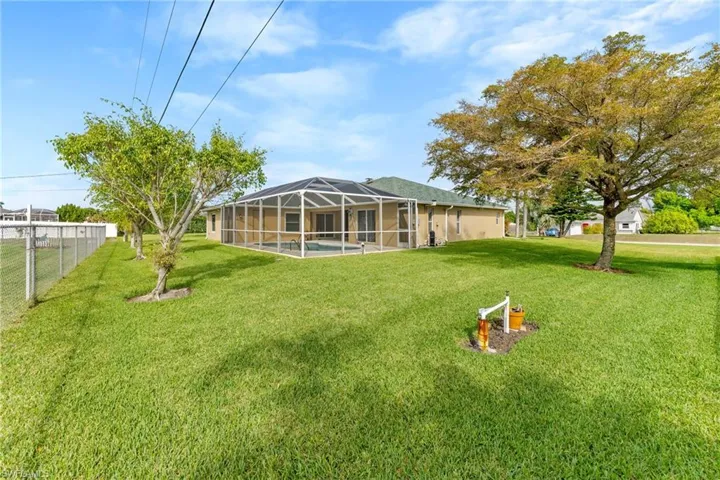 View of yard with a sunroom, a swimming pool, and a lanai