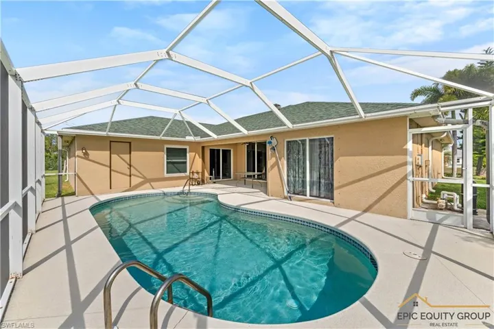 Outdoor pool with a sunroom, a patio, and a lanai