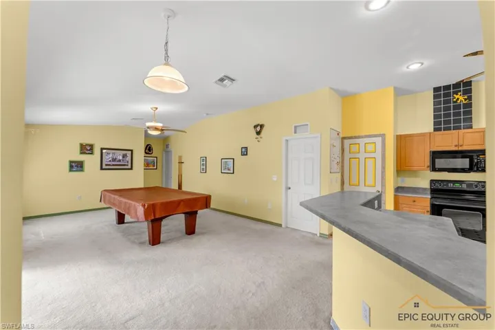 Game room with billiards, light carpet, and ceiling fan