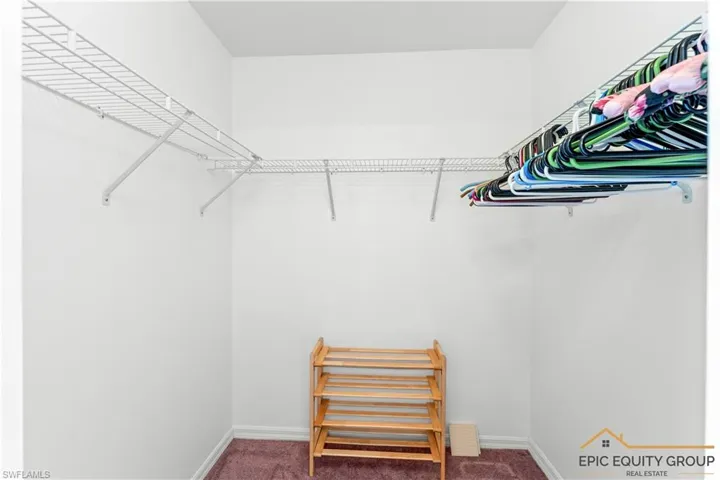 Walk in closet featuring carpet flooring