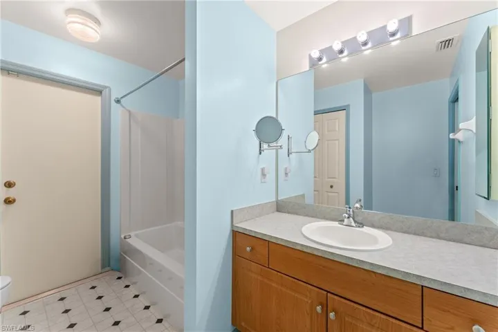 Bathroom with vanity and shower / tub combination