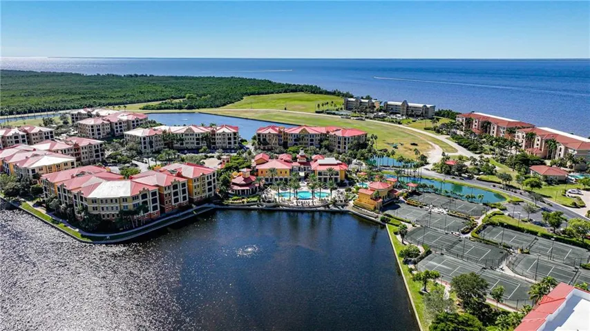 Aerial view of a large body of water and apartment complex / building