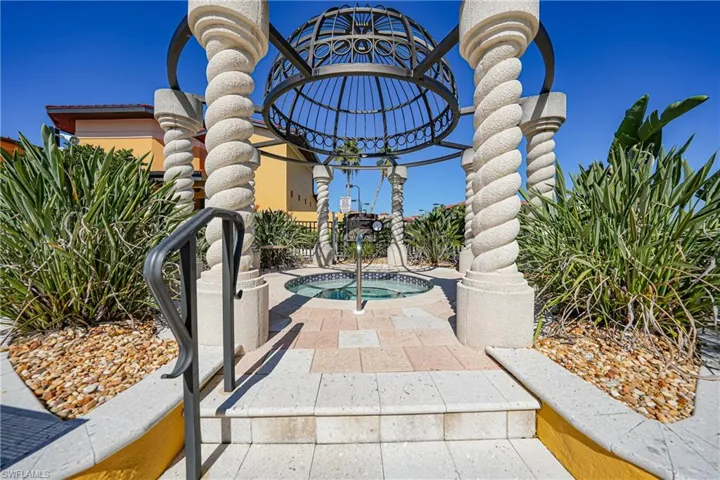 View of community featuring a patio area and a jacuzzi