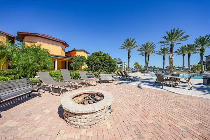 View of patio featuring a fire pit and a community pool