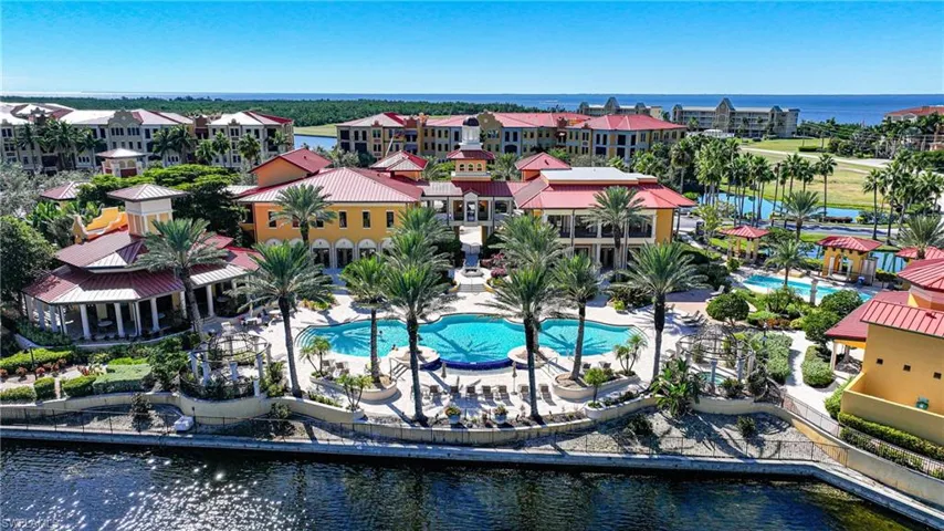 Bird's eye view of a nearby body of water and a pool area