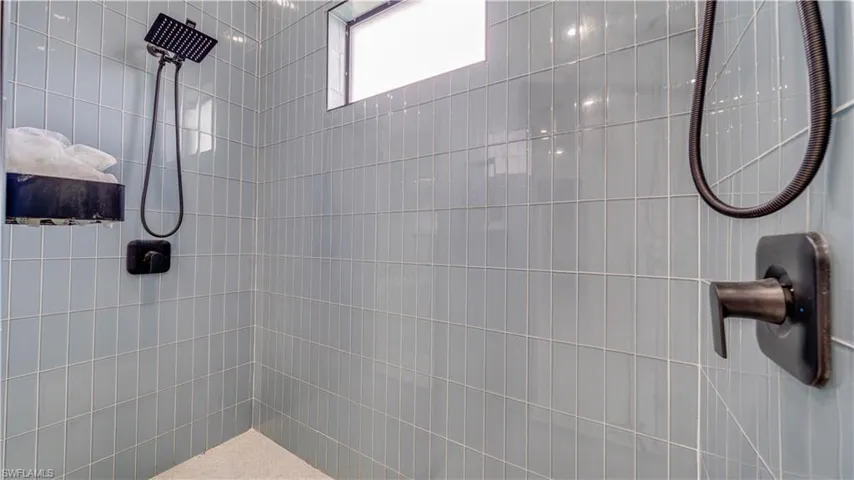 Primary bathroom walk thru shower with dual shower systems
