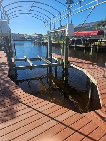 Dock area with boat lift and a water view