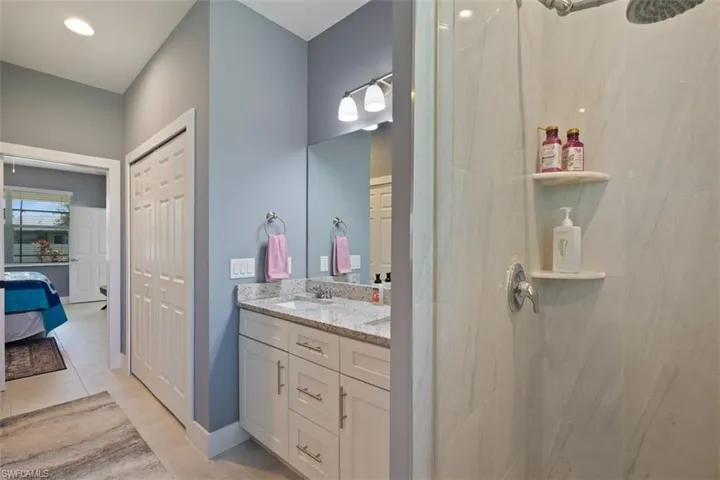 Ensuite bathroom with double vanity, walk in closet and shower
