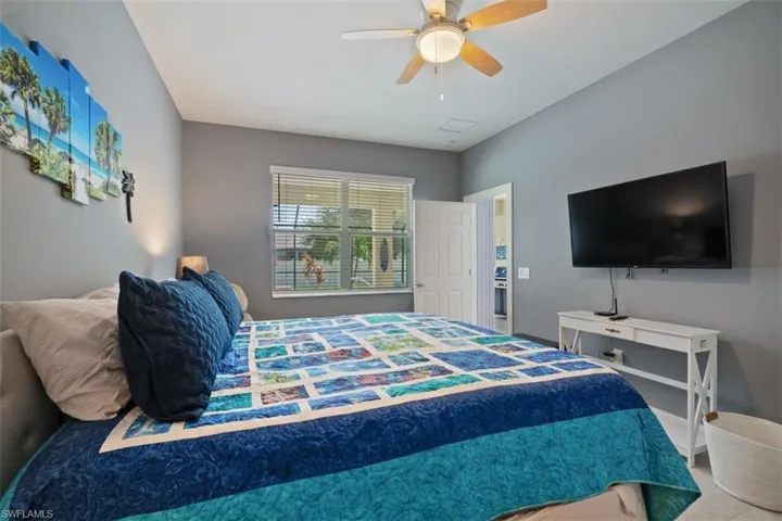 Bedroom featuring flatscreen tv and pool view