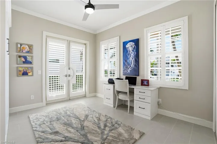 Office space featuring ornamental molding, a ceiling fan, and light tile patterned floors