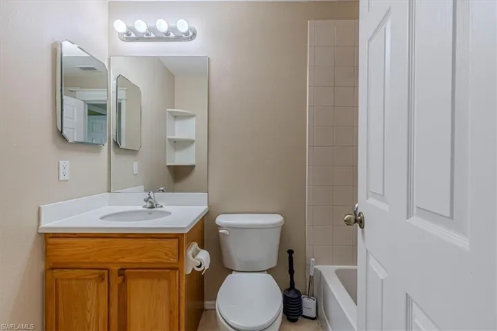 Bathroom with vanity and bathtub / shower combination