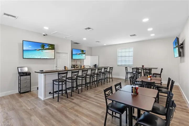 Dining space with light wood finished floors and recessed lighting