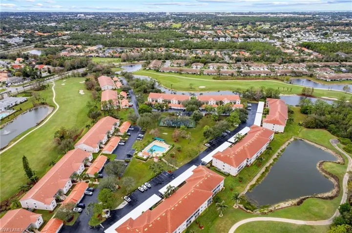 Aerial overview of property's location with a golf club, a large body of water, and nearby suburban area