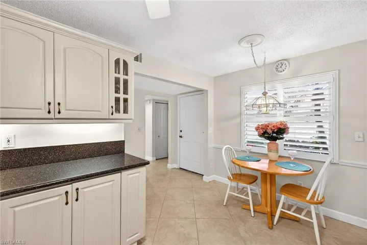 Dining space featuring a textured ceiling and light tile patterned floors